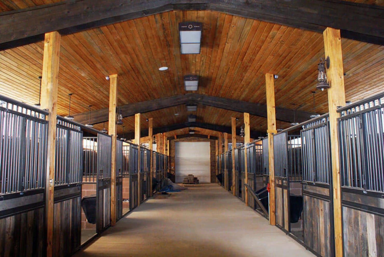 This is an image if a stunning horse stable built by Capital Steel. The interior is lined with wood for a classic, but modern look.